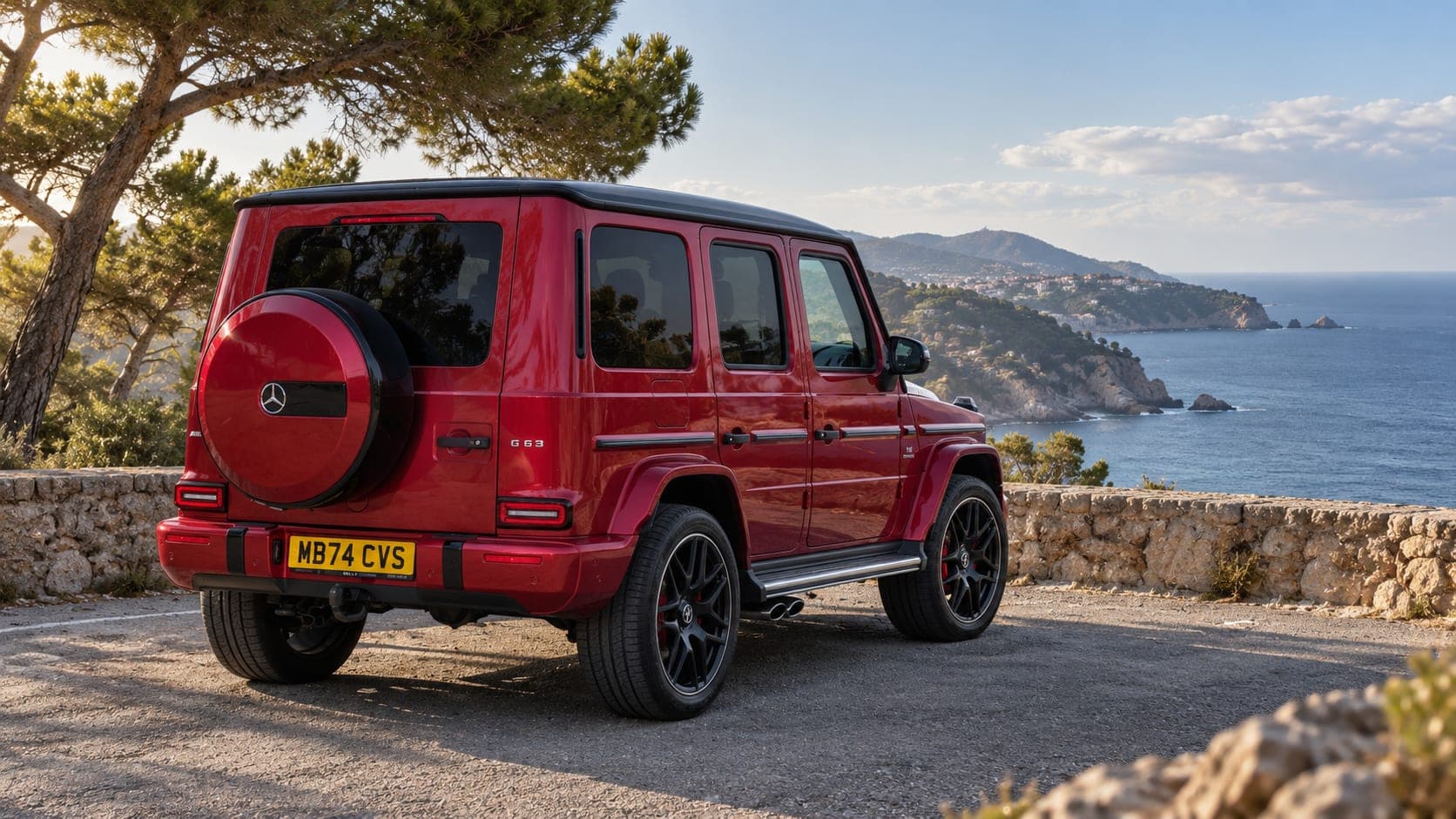 Rear three-quarter of the red Mercedes-AMG G63 on the coast