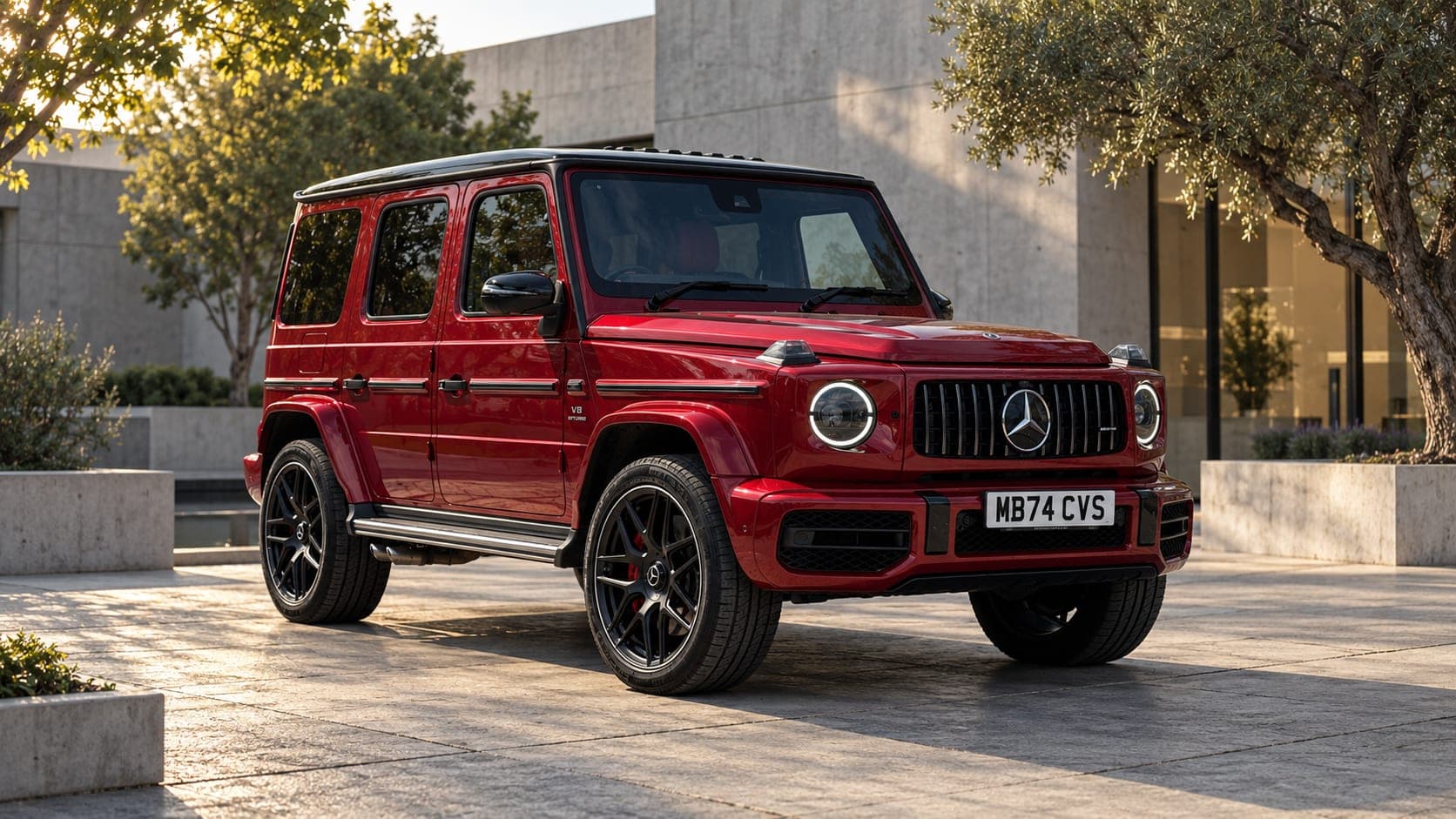 Red Mercedes-AMG G63, front three-quarter against modern architecture, available to hire from CVS Car Hire