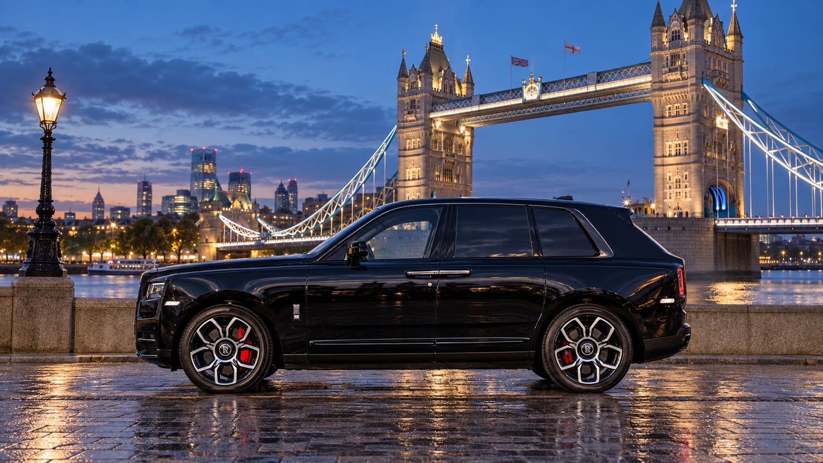 Black Rolls-Royce Cullinan Black Badge, side profile by Tower Bridge, London, available to hire from CVS Car Hire