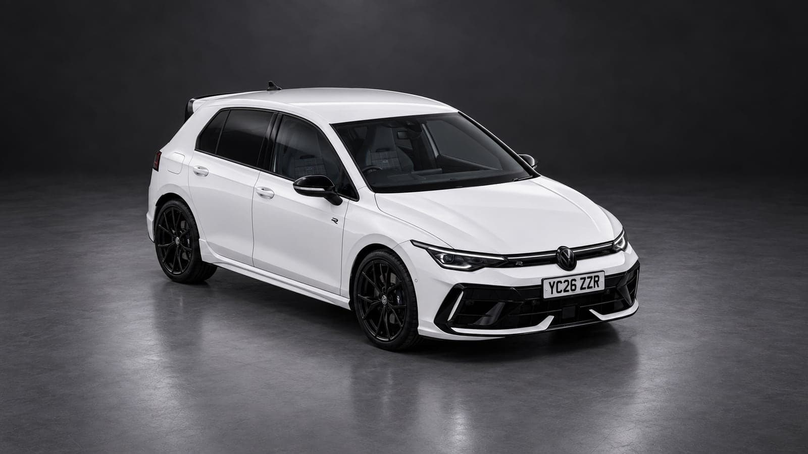 White Volkswagen Golf R — elevated front, studio