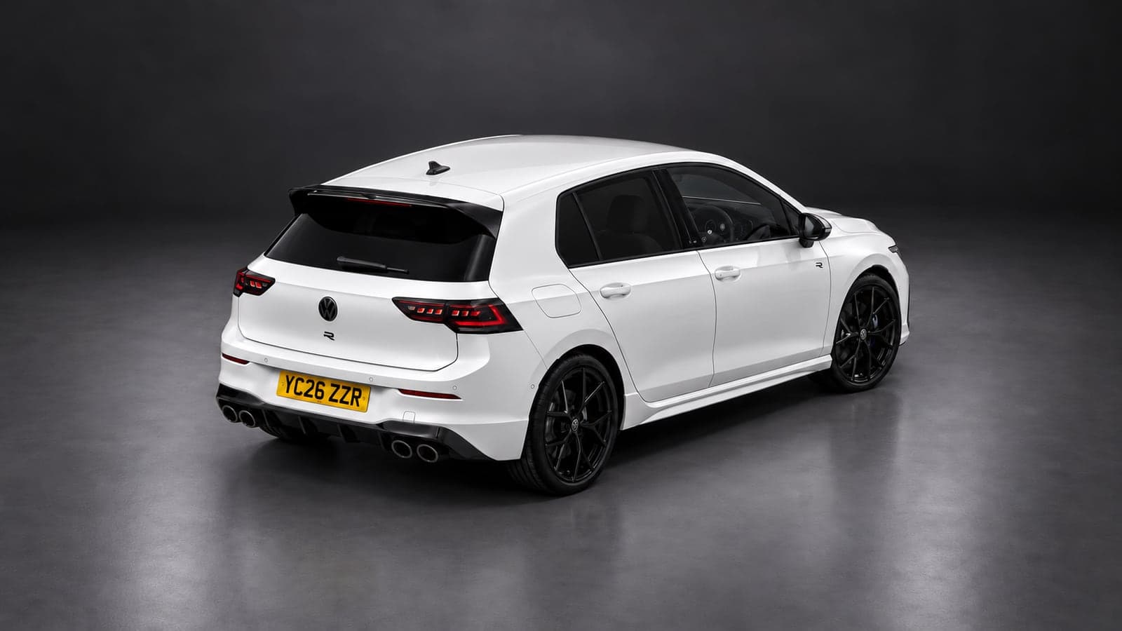 White Volkswagen Golf R — elevated rear, studio