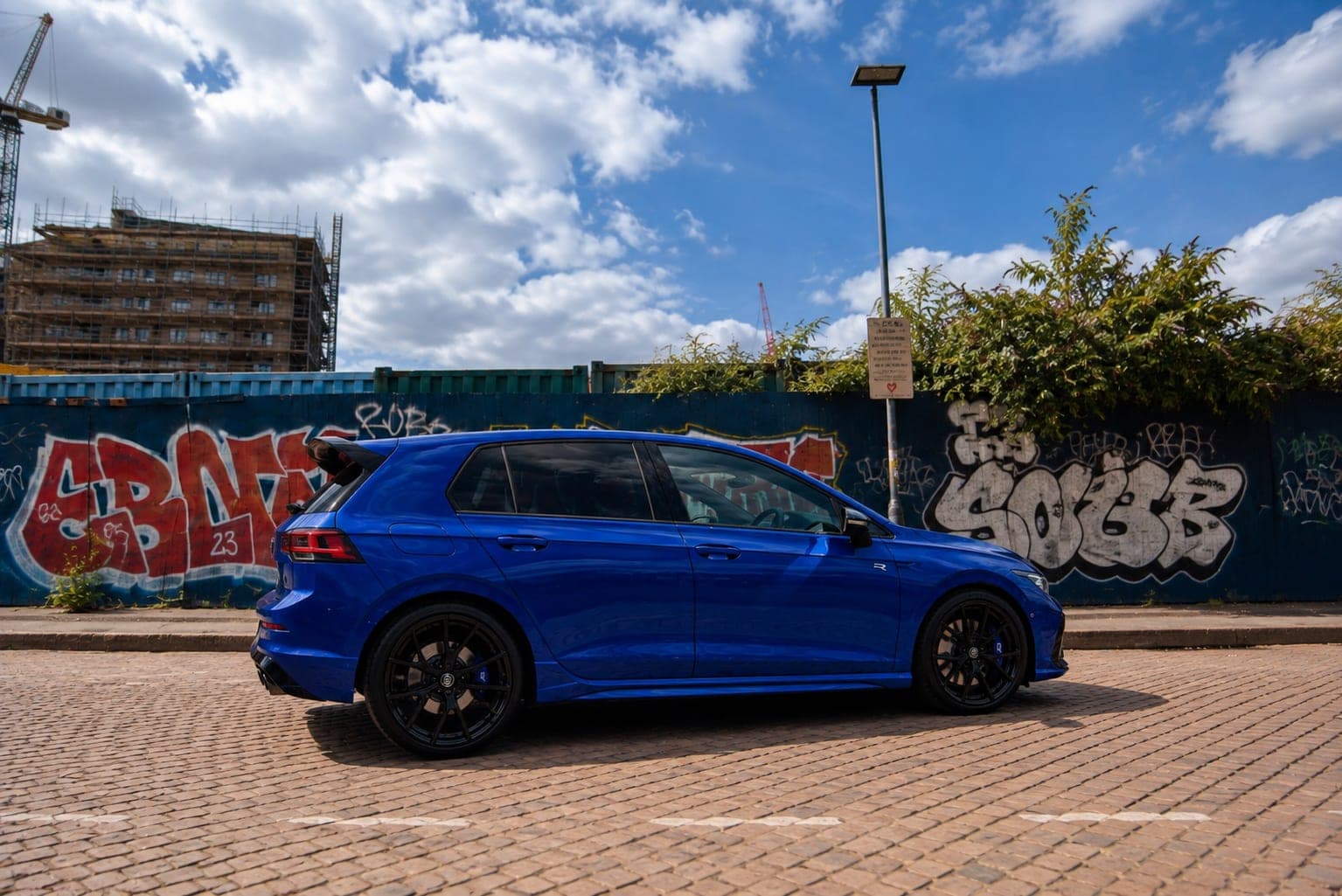 Side profile of the Lapiz Blue Volkswagen Golf R on black alloys