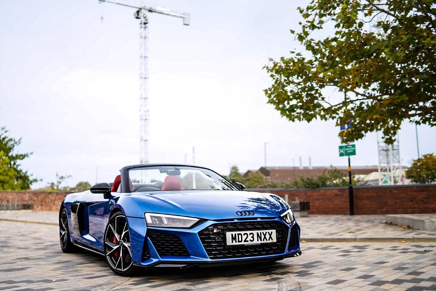 Front of the blue Audi R8 Spyder with the roof down