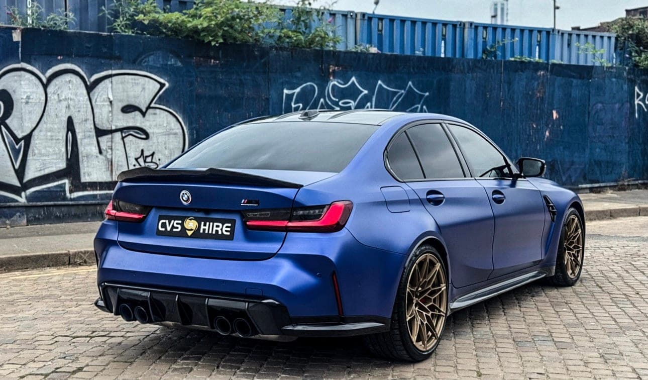 Rear three-quarter view of the matte blue BMW M3