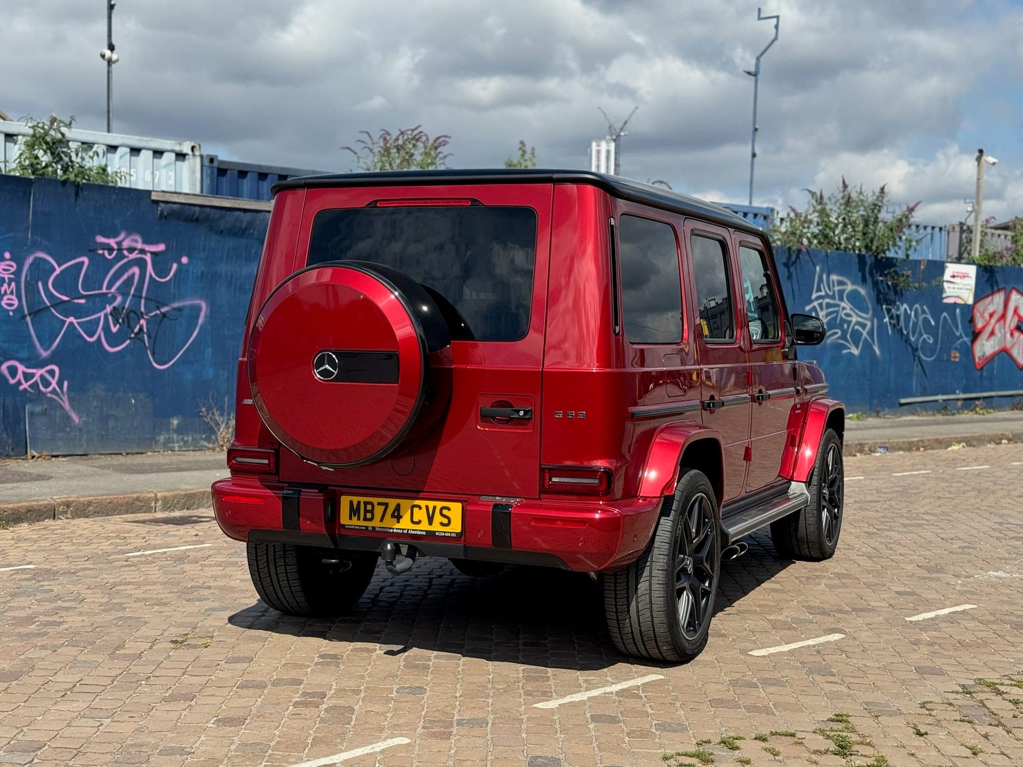 Rear of the red Mercedes-AMG G 63 with its side-hinged spare wheel