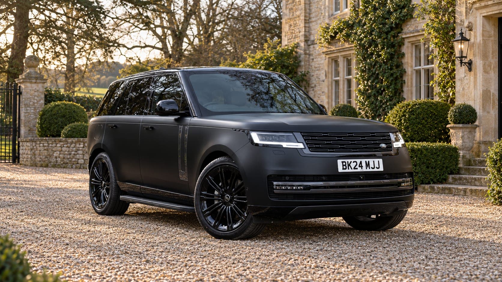 Matte black Range Rover Vogue outside a country manor, available to hire from CVS Car Hire